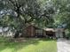 Charming single-story brick home featuring a two-car garage and a well-manicured front yard with a large shady tree at 1056 Yorktown Dr, Charleston, SC 29412