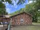 Side view of a brick home featuring a well-maintained yard, adding to the property's curb appeal and charm at 1056 Yorktown Dr, Charleston, SC 29412