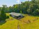 Aerial view of horse barn featuring fenced area, ample storage, and grazing area at 1133 Highway 311, Cross, SC 29436