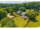 Estate aerial view showcasing a house, guest house, manicured landscaping, and expansive land at 1133 Highway 311, Cross, SC 29436