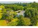 Aerial view highlighting the serene property with lush landscaping, beautiful trees, and garden at 1133 Highway 311, Cross, SC 29436