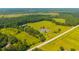 Expansive aerial view of a green landscape featuring a pond, road and lush trees at 1133 Highway 311, Cross, SC 29436
