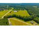 Panoramic aerial shot of a property featuring a pond, fields, and surrounding lush greenery at 1133 Highway 311, Cross, SC 29436