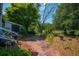 Charming backyard patio with a brick pathway, lush plants, and inviting outdoor space at 1133 Highway 311, Cross, SC 29436