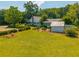 Beautiful white painted brick home featuring lush manicured yard and outbuilding at 1133 Highway 311, Cross, SC 29436