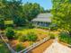 Charming two story home with inviting front porch, lush garden, and gravel drive at 1133 Highway 311, Cross, SC 29436