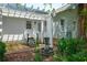 Charming home exterior with a beautiful trellis, landscaped garden and quaint water feature at 1133 Highway 311, Cross, SC 29436
