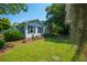 Quaint home exterior with a well-manicured lawn, mature trees, and a charming garden at 1133 Highway 311, Cross, SC 29436