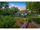 Charming cottage-style home with a manicured front lawn, inviting porch, and soft evening light at 1133 Highway 311, Cross, SC 29436