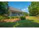 Charming home featuring a covered front porch, white railings, and lush landscaping at 1133 Highway 311, Cross, SC 29436