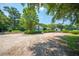 Charming home with a gravel driveway, manicured hedges, and a white picket fence at 1133 Highway 311, Cross, SC 29436