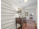 Hallway with white shiplap, a wooden console table, and a glimpse into the bright kitchen at 1133 Highway 311, Cross, SC 29436