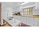 Well-lit kitchen with white cabinets, wood counters and an island at 1133 Highway 311, Cross, SC 29436
