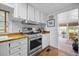 Clean kitchen featuring white cabinets, butcher block counters, and stainless steel appliances at 1133 Highway 311, Cross, SC 29436