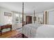 Spacious bedroom with a four-poster bed, hardwood floors, and natural light at 1133 Highway 311, Cross, SC 29436