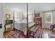Elegant bedroom showcasing a four-poster bed, fireplace, and vintage decor at 1133 Highway 311, Cross, SC 29436