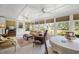 Inviting sunroom with a wall of windows, plenty of seating and beautiful views at 1133 Highway 311, Cross, SC 29436