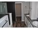 Modern bathroom with dual vanities, wood-look flooring, and sliding barn door at 123 Christina Ln, Summerville, SC 29483