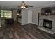 Open-concept living space with hardwood floors, fireplace, island, and modern kitchen featuring stainless appliances at 123 Christina Ln, Summerville, SC 29483