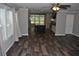 Open concept living room with wood-look flooring flows into kitchen with island at 123 Christina Ln, Summerville, SC 29483