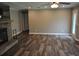 Cozy living room featuring a stone fireplace, wood-look flooring, and a ceiling fan at 123 Christina Ln, Summerville, SC 29483