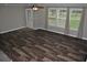 Well-lit living room features hard wood floors, a ceiling fan, and large windows overlooking the yard at 123 Christina Ln, Summerville, SC 29483