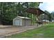 A metal outbuilding and covered area are on a well maintained lot with mature trees at 123 Christina Ln, Summerville, SC 29483