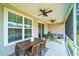 Covered back porch with ceiling fans offers a perfect spot for outdoor dining and relaxation at 1250 Hammrick Ln, Johns Island, SC 29455