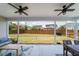 Enjoy outdoor living on this screened-in back porch with a view of the backyard with mature trees at 1250 Hammrick Ln, Johns Island, SC 29455