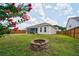 Spacious backyard features a fire pit, landscaping, and screened in porch, perfect for entertaining guests at 1250 Hammrick Ln, Johns Island, SC 29455