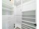 Bright, walk-in closet features custom shelving, drawers and ample storage space with multiple hanging rods at 1250 Hammrick Ln, Johns Island, SC 29455