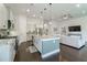 Bright kitchen boasts granite countertops, stainless appliances, island with pendant lighting, and an adjacent living area at 1250 Hammrick Ln, Johns Island, SC 29455