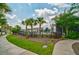 Community pool area surrounded by palm trees, lush landscaping and a black wrought iron fence at 1250 Hammrick Ln, Johns Island, SC 29455