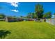 Expansive backyard featuring green grass, a storage shed, and a covered parking area at 127 Rahway Rd, Goose Creek, SC 29445
