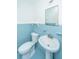 Quaint blue bathroom with pedestal sink and tiled walls at 127 Rahway Rd, Goose Creek, SC 29445