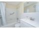 Well-lit bathroom with a tub, shower, white tiled walls, and modern fixtures at 127 Rahway Rd, Goose Creek, SC 29445