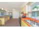 Kitchen with double sink, window, black appliances, and breakfast bar at 127 Rahway Rd, Goose Creek, SC 29445