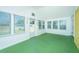 Sunroom featuring large windows and a green floor at 127 Rahway Rd, Goose Creek, SC 29445