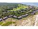 Aerial view of a beachside community next to a golf course and lush foliage at 1334 Pelican Watch Villas, Seabrook Island, SC 29455