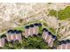 Birds eye view of rooftops nestled between trees, near a beach and wooded walkways at 1334 Pelican Watch Villas, Seabrook Island, SC 29455