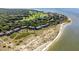 Stunning aerial of beach condos with easy access to the beach, lush trees, and beautiful shoreline at 1334 Pelican Watch Villas, Seabrook Island, SC 29455
