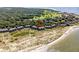 Beautiful aerial view of beachside condos near golf course, lush trees, and sandy shoreline at 1334 Pelican Watch Villas, Seabrook Island, SC 29455