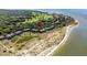 Stunning aerial of beach condos with easy access to the beach, lush trees, and beautiful shoreline at 1334 Pelican Watch Villas, Seabrook Island, SC 29455