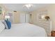 Bright bedroom features a comfortable queen bed, soft lighting, and a closet for ample storage at 1334 Pelican Watch Villas, Seabrook Island, SC 29455