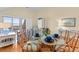 Cozy dining area with a glass table set for four, complemented by blue accents and a view at 1334 Pelican Watch Villas, Seabrook Island, SC 29455