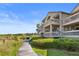 Charming condos feature private balconies and lush landscaping along a scenic wooden walkway at 1334 Pelican Watch Villas, Seabrook Island, SC 29455