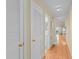 Hallway leads to a bright living space with wood floors, white doors, and neutral walls at 1334 Pelican Watch Villas, Seabrook Island, SC 29455