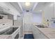 Well-lit kitchen with white appliances, tile countertops, and blue patterned walls at 1334 Pelican Watch Villas, Seabrook Island, SC 29455