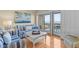 Cozy living room with stylish nautical décor and balcony access, perfect for seaside relaxation at 1334 Pelican Watch Villas, Seabrook Island, SC 29455