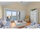 Comfortable living room with striped seating, white furniture, and deck access, perfect for relaxation at 1334 Pelican Watch Villas, Seabrook Island, SC 29455